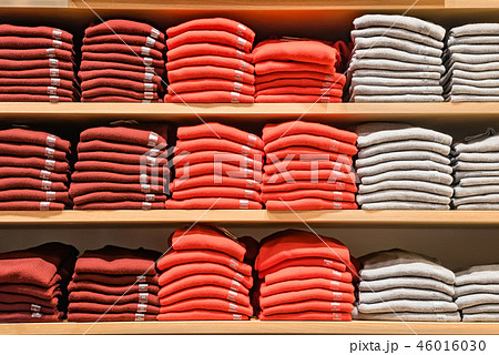 Clothes displayed in store. Copy spase for text. Lot warm sweaters of different color are neatly 46016030