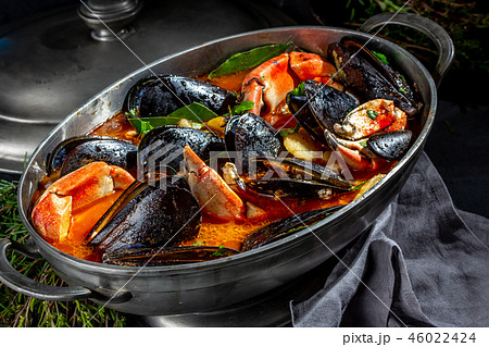 Seafood soup with mussels and crabs in metal pot 46022424
