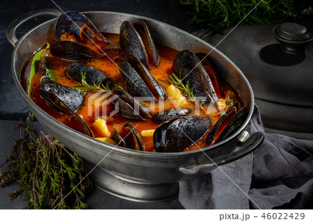 Seafood soup with mussels and crabs in metal pot 46022429