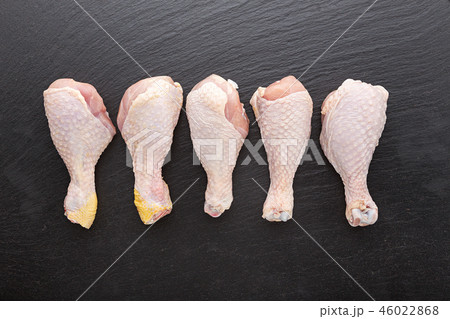 raw chicken legs on a black background raw chicken legs on a black background 46022868