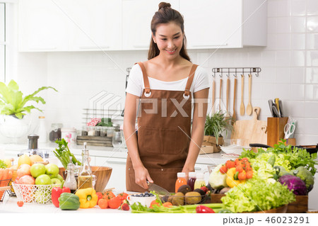 Asian woman in a kitchen preparing healthy meal Asian woman in a kitchen preparing healthy meal 46023291