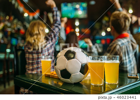 Ball and beer on the table in sports bar 46023441