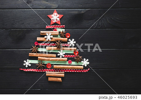 Christmas tree made of cinnamon, anise, ribbons and buttons Christmas tree made of cinnamon, anise, ribbons and buttons 46025693