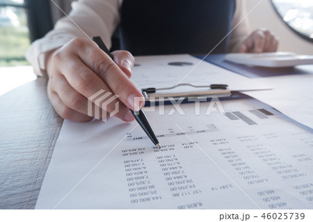Female working in office/studying using calculator Female working in office/studying using calculator 46025739