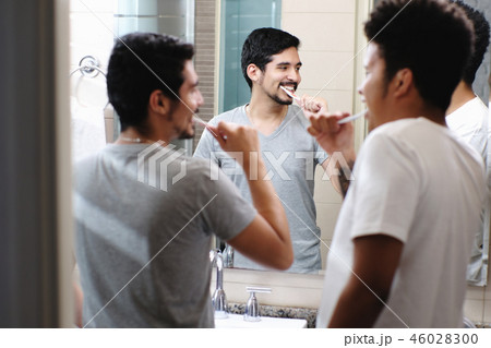 Happy Gay Couple Brushing Teeth In Bathroom Happy Gay Couple Brushing Teeth In Bathroom 46028300