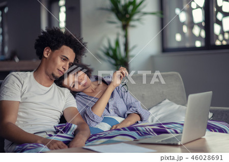 Worried young couple discussing bills at home Worried young couple discussing bills at home 46028691