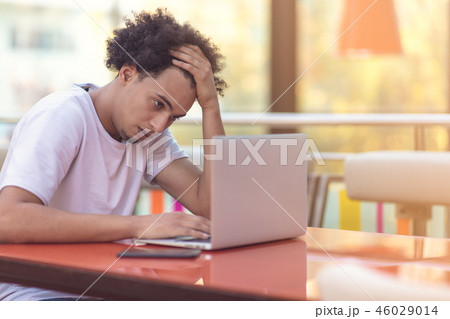 Image of african american businessman working on his laptop. Handsome young man at his desk. Image of african american businessman working on his laptop. Handsome young man at his desk. 46029014