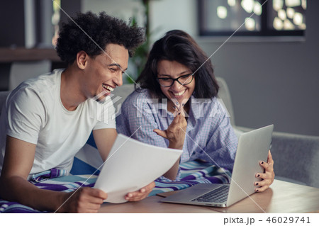 Worried young couple discussing bills at home Worried young couple discussing bills at home 46029741