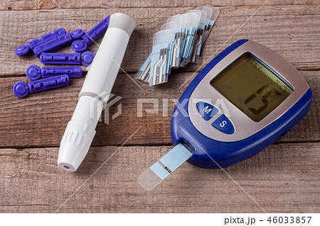 blood glucose meter on an old wooden background 46033857