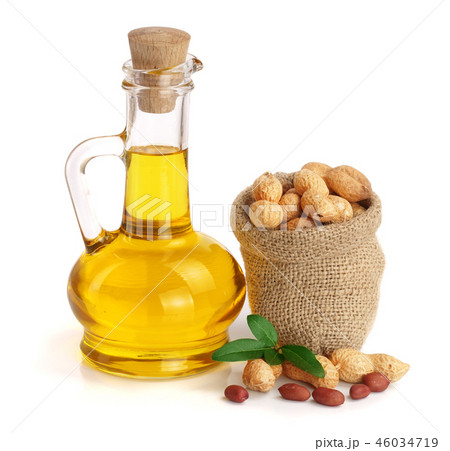 peanut oil in a glass bottle with peanuts in bag 46034719