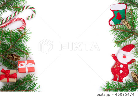 Christmas Frame of Fir tree branch with candy canes and Santa isolated on white background with copy 46035474