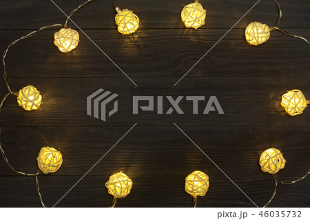 christmas garland lights on black wooden background with copy space for your text. Top view 46035732