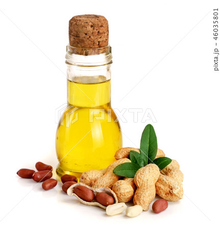 peanut oil in a glass bottle with peanuts peanut oil in a glass bottle with peanuts 46035801