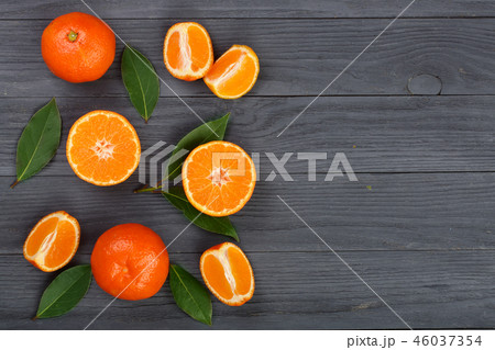 tangerine with leaves on black wooden background with copy space for your text. Flat lay, top view 46037354