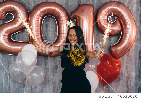 Woman holding balloons looking at camera. Celebration holiday new year Woman holding balloons looking at camera. Celebration holiday new year 46039020