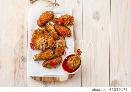 Chicken nuggets with sauce and pepper on a white board. Copy space. 46039171
