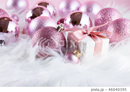 Pink Christmas decorations on white fur Pink Christmas decorations on white fur 46040395
