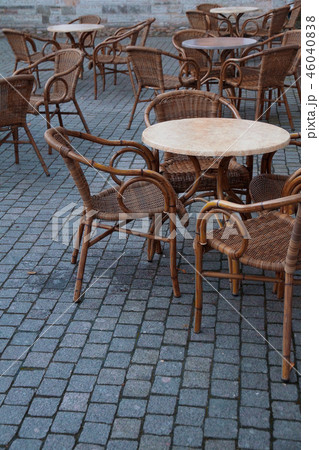stone table and wooden chairs of street cafe in evening stone table and wooden chairs of street cafe in evening 46040838
