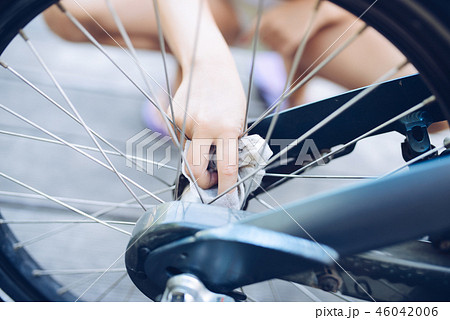 child girl cleaning her bike child girl cleaning her bike 46042006