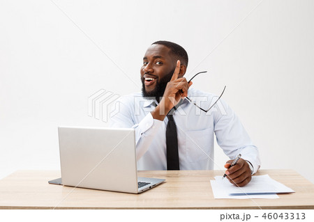 thoughtful young african american businessman working on laptop computer thoughtful young african american businessman working on laptop computer 46043313