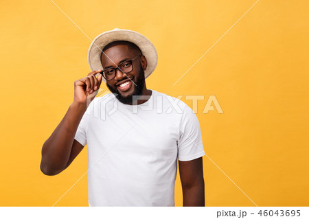 Single handsome muscular Black man with shaved head, folded arms and cheerful expression 46043695