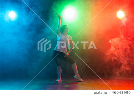 Modern dance, sport and people concept - young woman dancing jazz funk in the darkness under Modern dance, sport and people concept - young woman dancing jazz funk in the darkness under 46043990