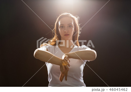 Young woman jazz funk dancer exercising dance moves in studio 46045462
