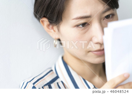 会議資料をチェックする鋭い視線の女性キャリアウーマン 46048524