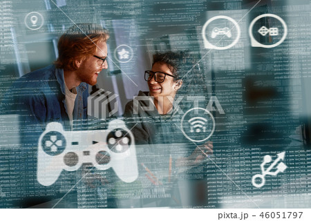 Young indian woman game developer and red haired man are laughting about idea Young indian woman game developer and red haired man are laughting about idea 46051797