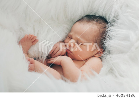 Portrait of newborn baby on a white background. Portrait of newborn baby on a white background. 46054136