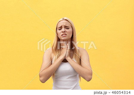 Tired young caucasian woman having pan in neck. Isolated over yellow background. 46054314