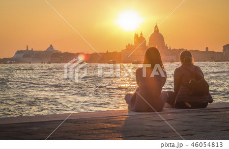 Two girls admire the scenic sunset  in Venice 46054813