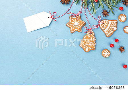 Gingerbread cookies hanging over blue background 46058863