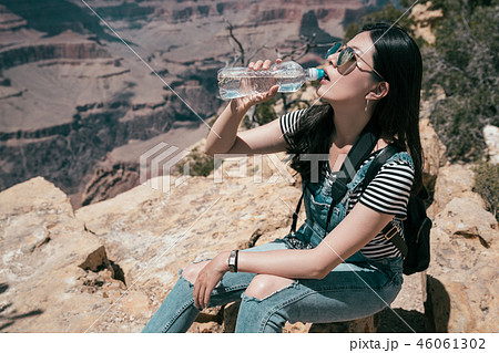 beautiful female hiker traveler sitting outdoors beautiful female hiker traveler sitting outdoors 46061302