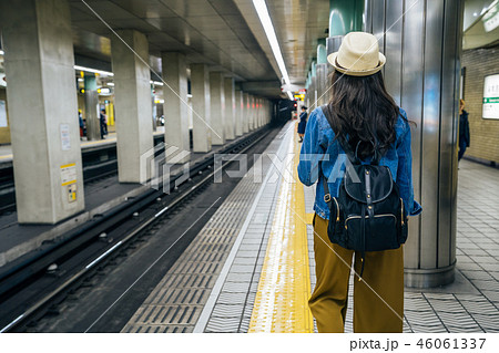 female backpacker walking in subway station female backpacker walking in subway station 46061337