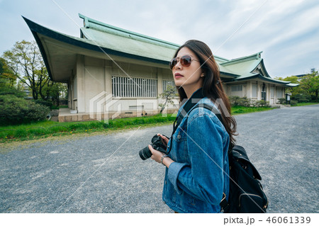 young girl tourist holding camera in hands young girl tourist holding camera in hands 46061339