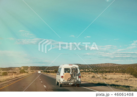 van driving with bicycle hanging outside van driving with bicycle hanging outside 46061408