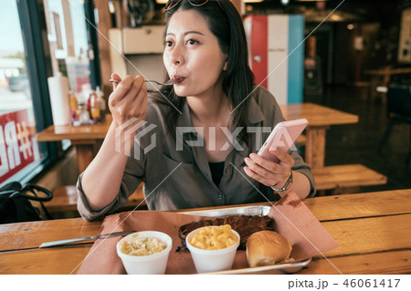young lady eating meal with fork. young lady eating meal with fork. 46061417
