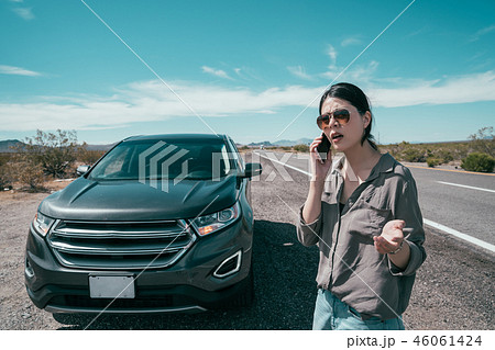 asian girl near a broken car on the country road 46061424