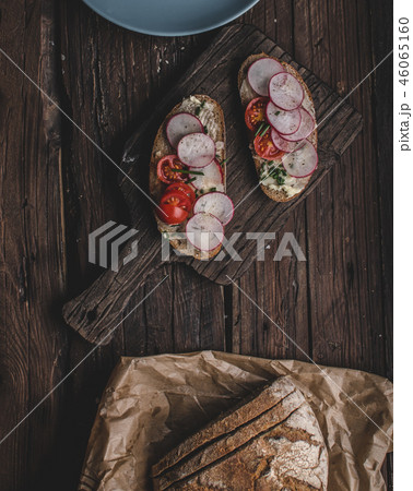Homemade bread with fresh creame, herbs and radishes Homemade bread with fresh creame, herbs and radishes 46065160