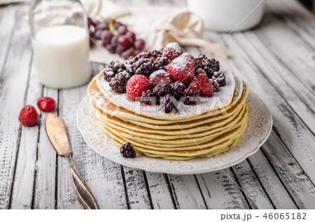 Homemade crepes with frozen berries, topped sugar Homemade crepes with frozen berries, topped sugar 46065182