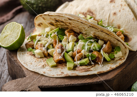 Homemade chicken thigh grilled, fresh avocado in tortilla Homemade chicken thigh grilled, fresh avocado in tortilla 46065210