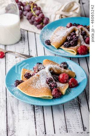 Homemade crepes with frozen berries, topped sugar 46065242