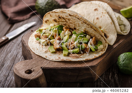 Homemade chicken thigh grilled, fresh avocado in tortilla Homemade chicken thigh grilled, fresh avocado in tortilla 46065282