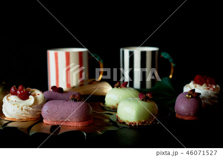 Moscovie cakes purple and lemon yellow. Pistachio and fruit. Meringue Anna Pavlova .Culinary art Moscovie cakes purple and lemon yellow. Pistachio and fruit. Meringue Anna Pavlova .Culinary art 46071527