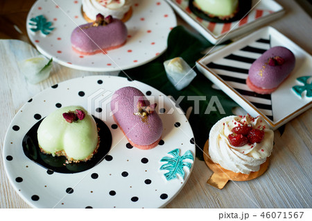 Moscovie cakes purple and lemon yellow. Pistachio and fruit. Meringue Anna Pavlova .Culinary art. On 46071567