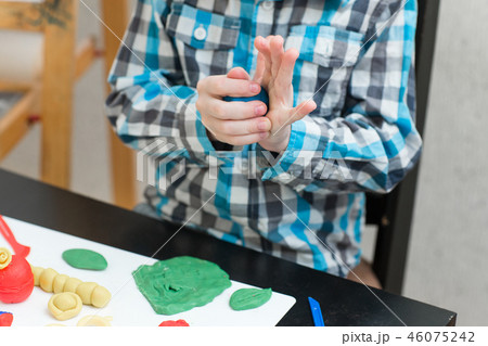 boy sculpts from plasticine at home boy sculpts from plasticine at home 46075242