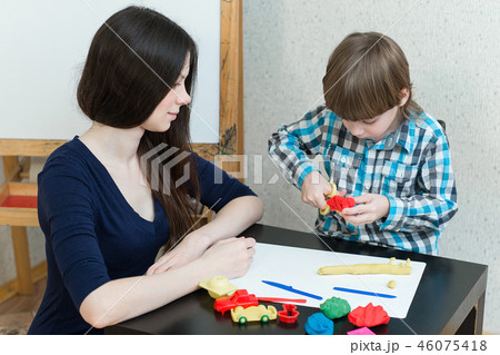 child kid boy and mother play colorful clay 46075418