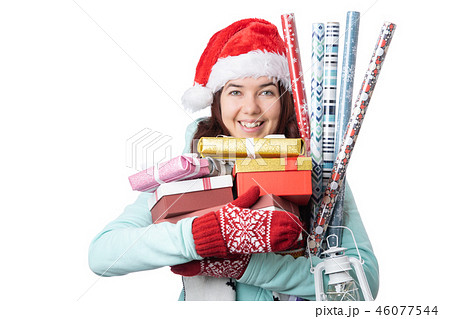 Photo of woman in Santa's cap with boxes with gifts with wrapping paper Photo of woman in Santa's cap with boxes with gifts with wrapping paper 46077544
