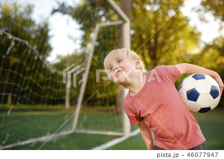 Little boy having fun playing a soccer/football 46077947